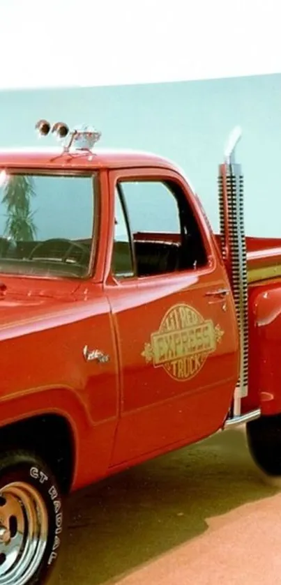 Vintage red truck with classic styling on a clear day.