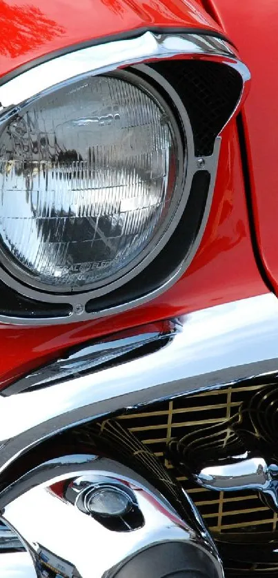 Close-up of a classic red vintage car with chrome detailing.