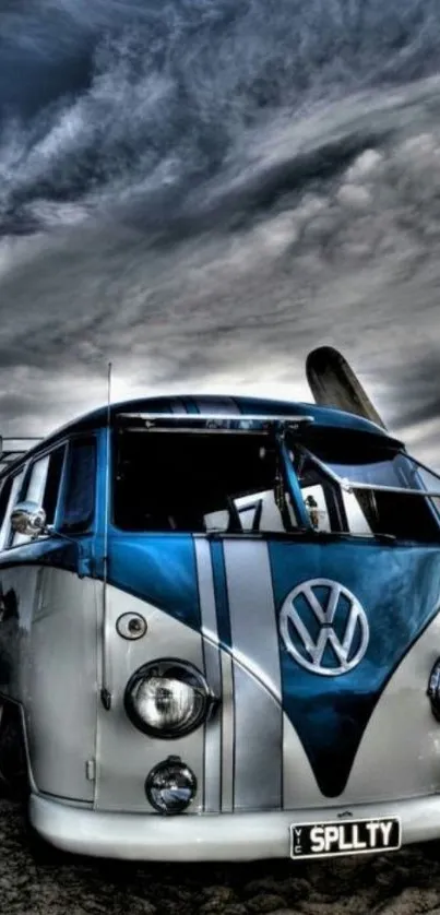 A classic van on a beach under a dramatic cloudy sky.