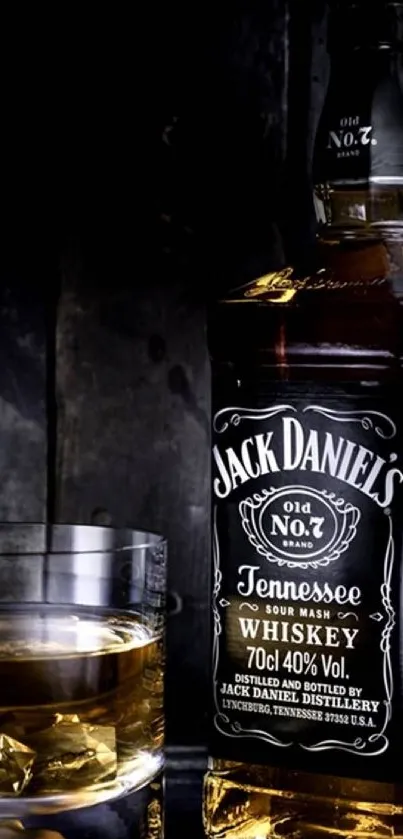 Elegant whiskey bottle and glass with dark background.