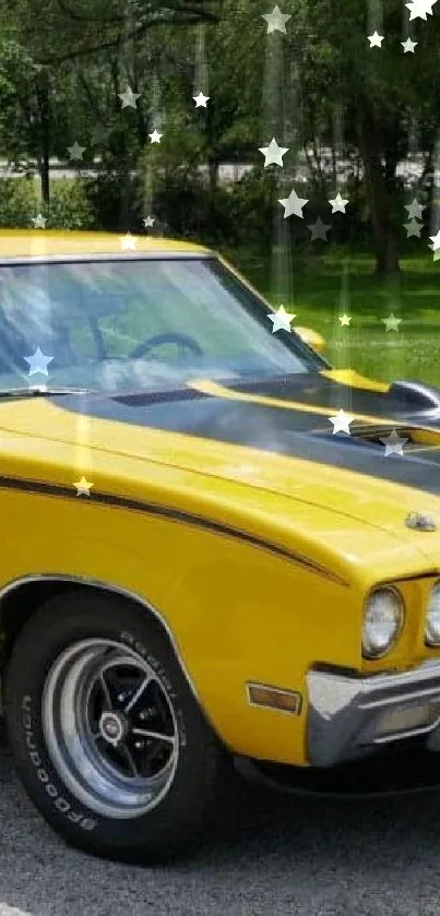 Yellow muscle car on driveway with green background.