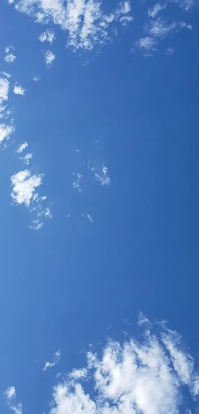 Clear blue sky with scattered white clouds wallpaper.