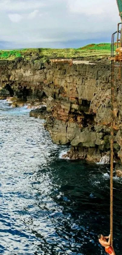 Cliff diver over rocky ocean water.