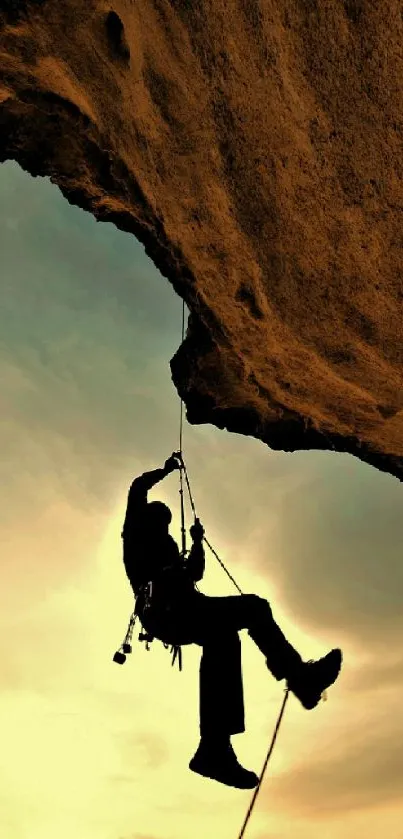 Silhouette of a climber against a dramatic sunset sky.