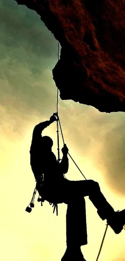 Silhouette of a climber against a golden sky.