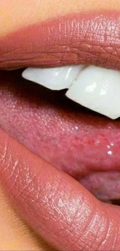 Close-up view of lips with pink lipstick and white teeth.