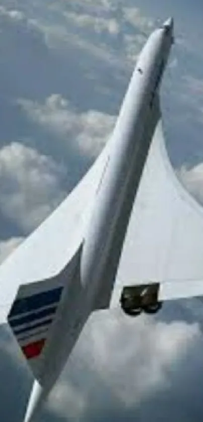 Sleek airplane soaring in blue sky amidst fluffy clouds.