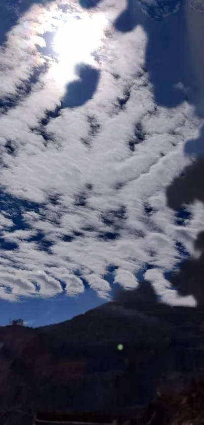 Blue sky with fluffy white clouds and sunlight.