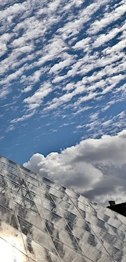 Glass pyramid beneath a vibrant cloudy sky.