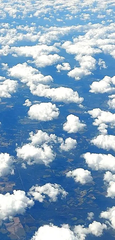 Aerial view of fluffy white clouds over a blue sky landscape.