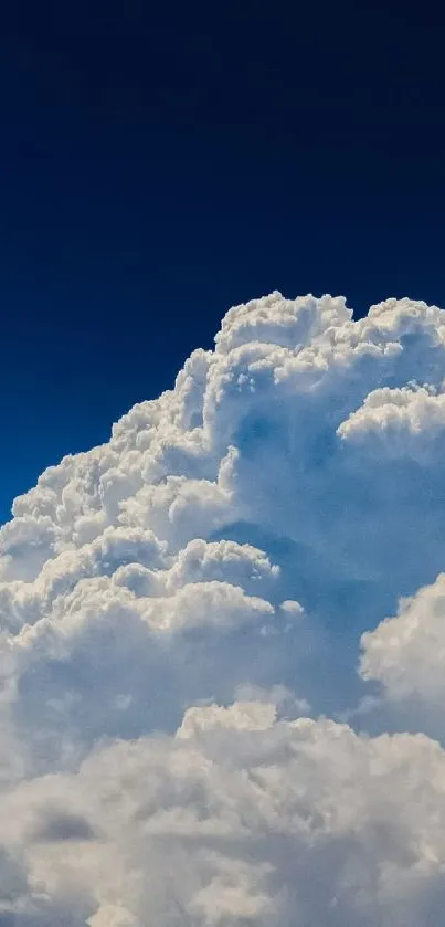 Cloudy sky with billowing clouds under a deep blue atmosphere.