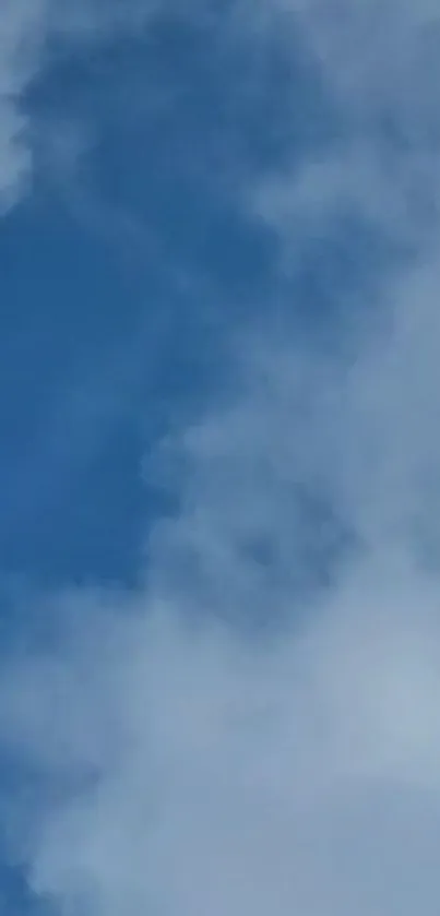 Serene clouds float in a bright blue sky.