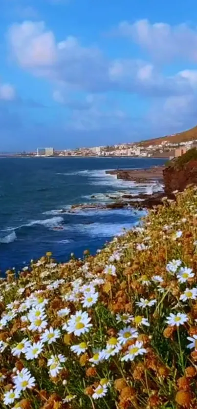 Coastal landscape with daisies and ocean waves under a blue sky.