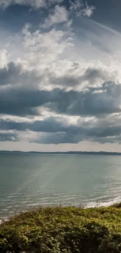 Scenic coastal view with ocean and clouds.