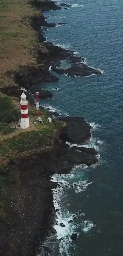 Aerial view of a lighthouse by the ocean with rocky cliffs.