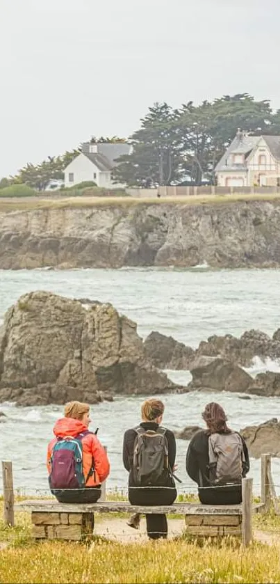 Friends sitting on a bench overlooking a coastal landscape.