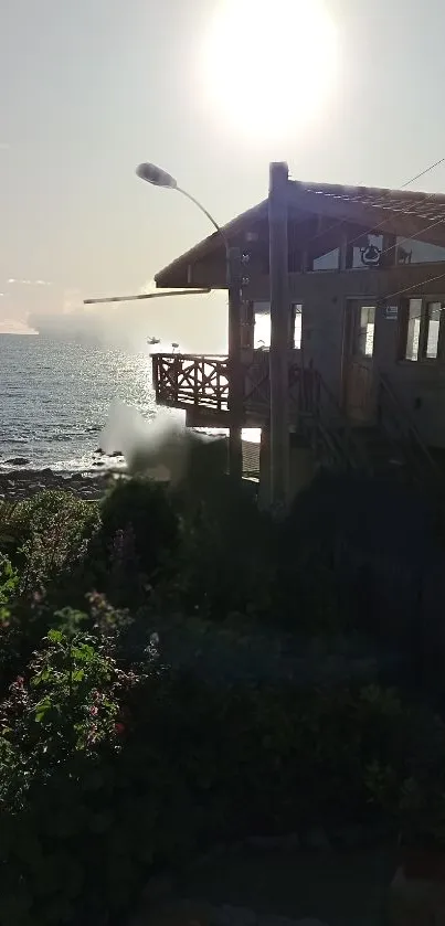 Sunset over a seaside cabin with ocean view, ideal for mobile wallpaper.