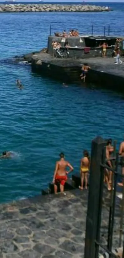 Coastal view with swimmers and rocky cliffs by the ocean.