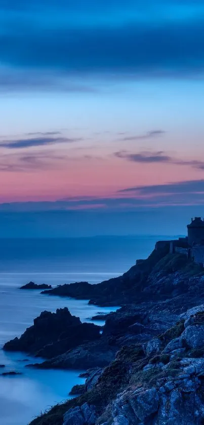 Serene coastal twilight scene with cliffs and deep blue sky.