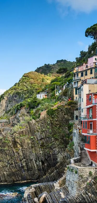 Colorful cliffside village scene overlooking the ocean.