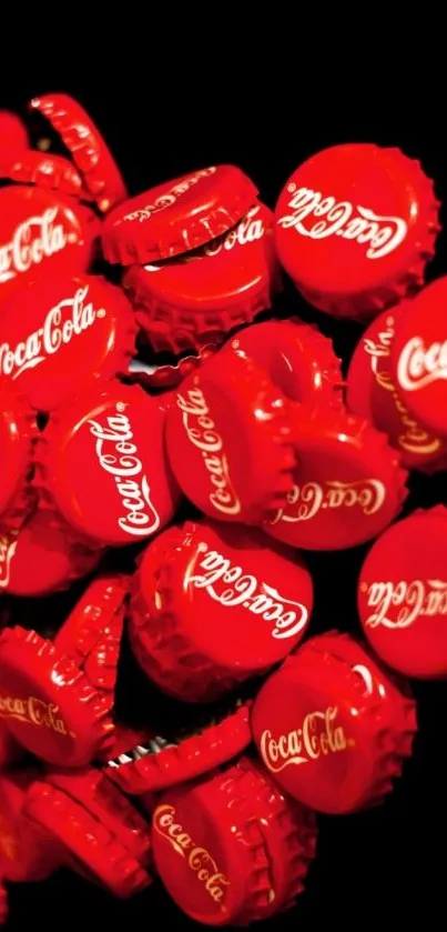 Red Coca Cola bottle caps against a black background.