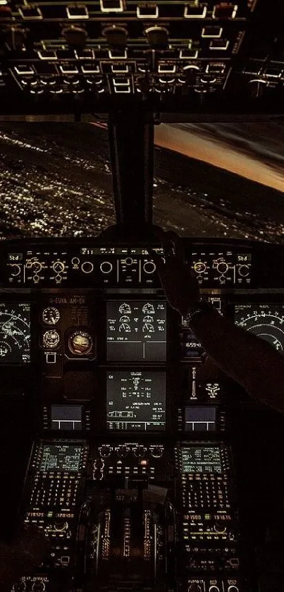 Illuminated airplane cockpit at night with view of city lights.