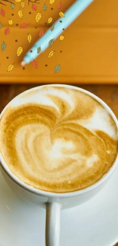 Latte coffee with swirling art and autumn leaves on a rustic table.