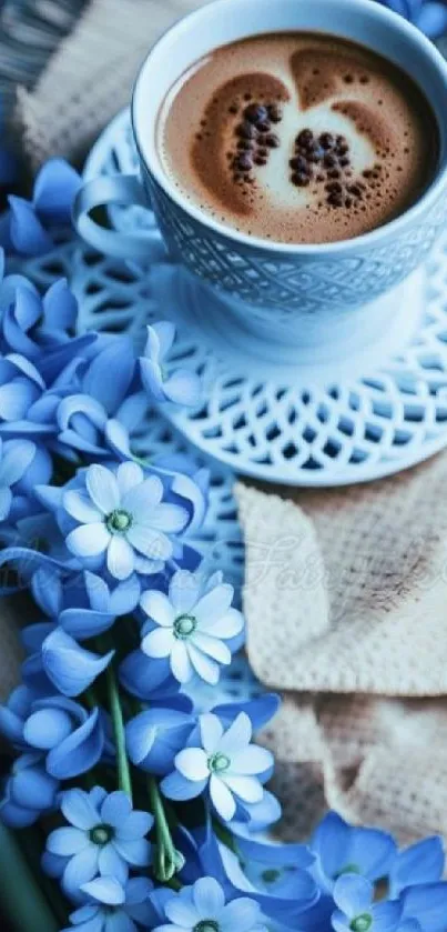 Cup of coffee with blue flowers on a decorative plate.