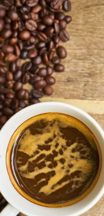 Top view of coffee cup and beans on wooden surface.