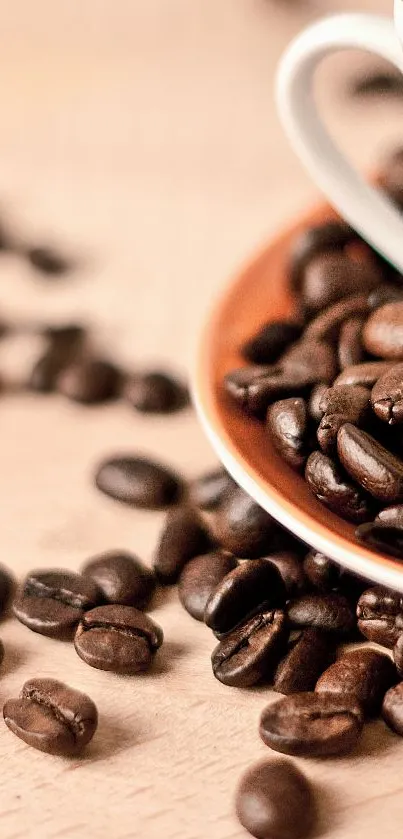 Coffee beans spilling over a patterned cup on a wooden surface.