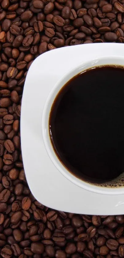White cup filled with coffee on a background of coffee beans.