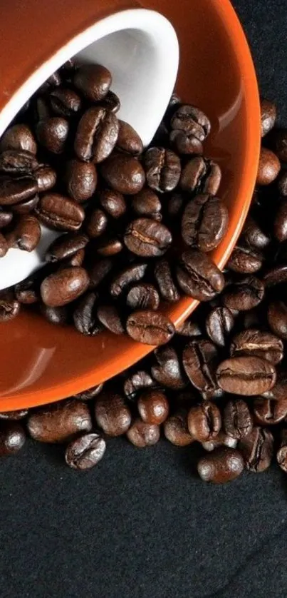 Coffee beans spilled from a brown cup on a black background wallpaper.