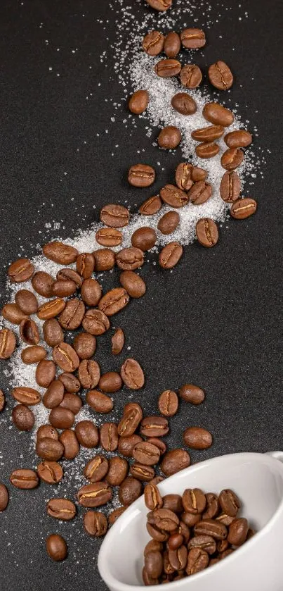 Dark wallpaper with coffee beans spilling from a white cup on a dark surface.