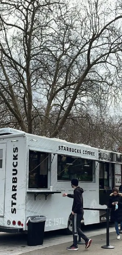 Starbucks coffee truck in a winter park scene.