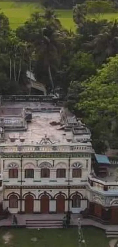 Aerial view of a colonial mansion surrounded by lush greenery.