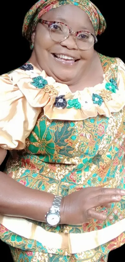 Smiling woman in colorful African attire.