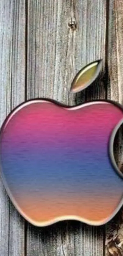 Colorful Apple logo with gradient on rustic wood background.