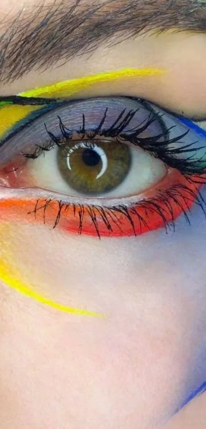 Close-up of an eye with artistic colorful paint streaks on skin.