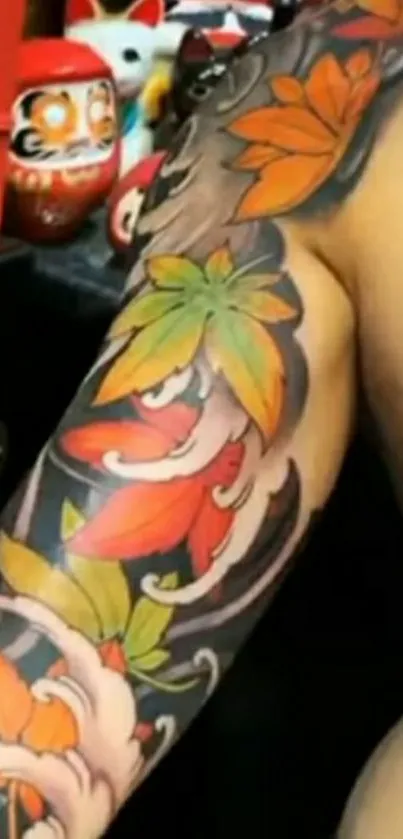 Vibrant tattoo design with colorful leaves on an arm in a mobile wallpaper.