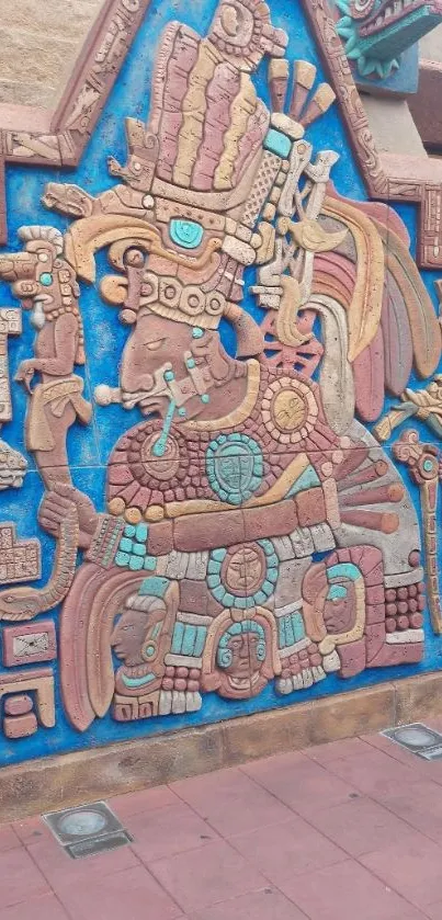 Colorful Aztec mural with blue and brown intricate designs.