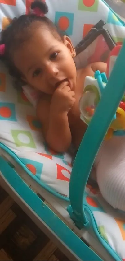 Baby in a colorful stroller with playful patterns.