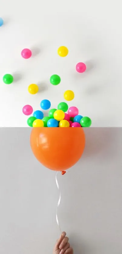 Orange balloon releasing colorful balls against neutral background.