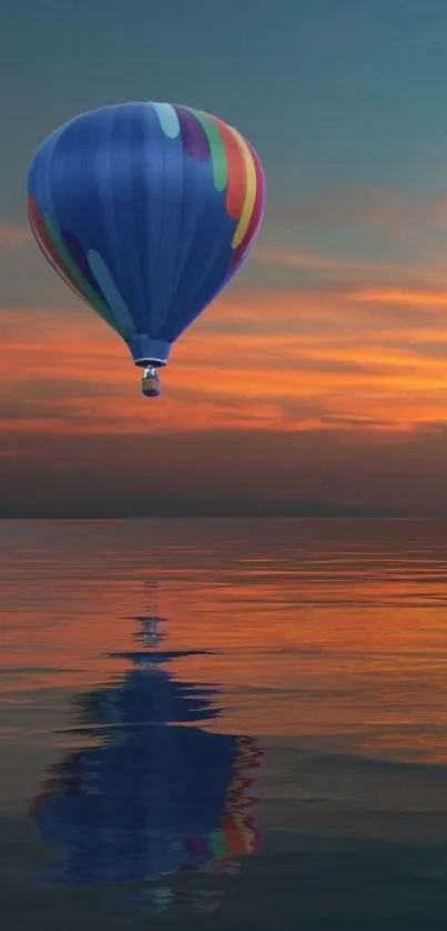 Hot air balloon floats over ocean at sunset.