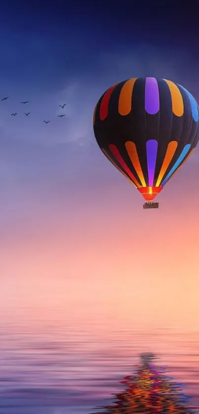 Vibrant hot air balloon floating under a gradient sunset sky with reflection on water.