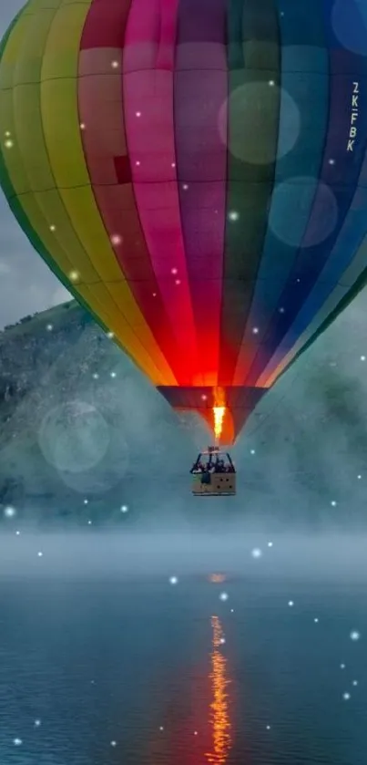 Colorful hot air balloon hovering over a calm lake at sunrise.