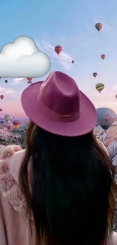 Person in a pink hat watching colorful hot air balloons in a blue sky.