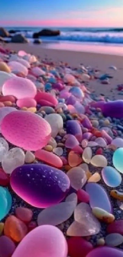 Colorful beach pebbles on a sandy shore during sunset.