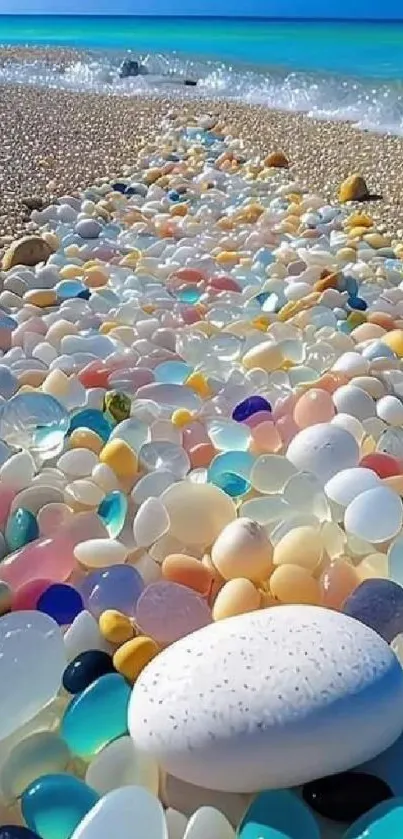 Colorful pebbles on a sandy beach by the ocean.