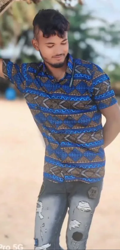 Young man in colorful shirt on beach wallpaper.