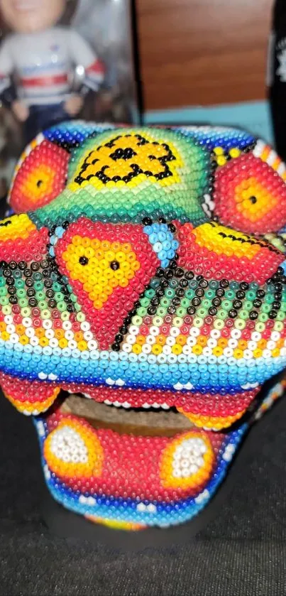 Colorful beaded skull art with vibrant patterns.